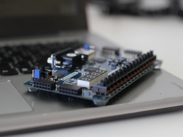 FPGA development board resting on a laptop