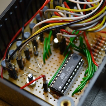 Hand-wired prototype board with a microcontroller and colorful jumper wires